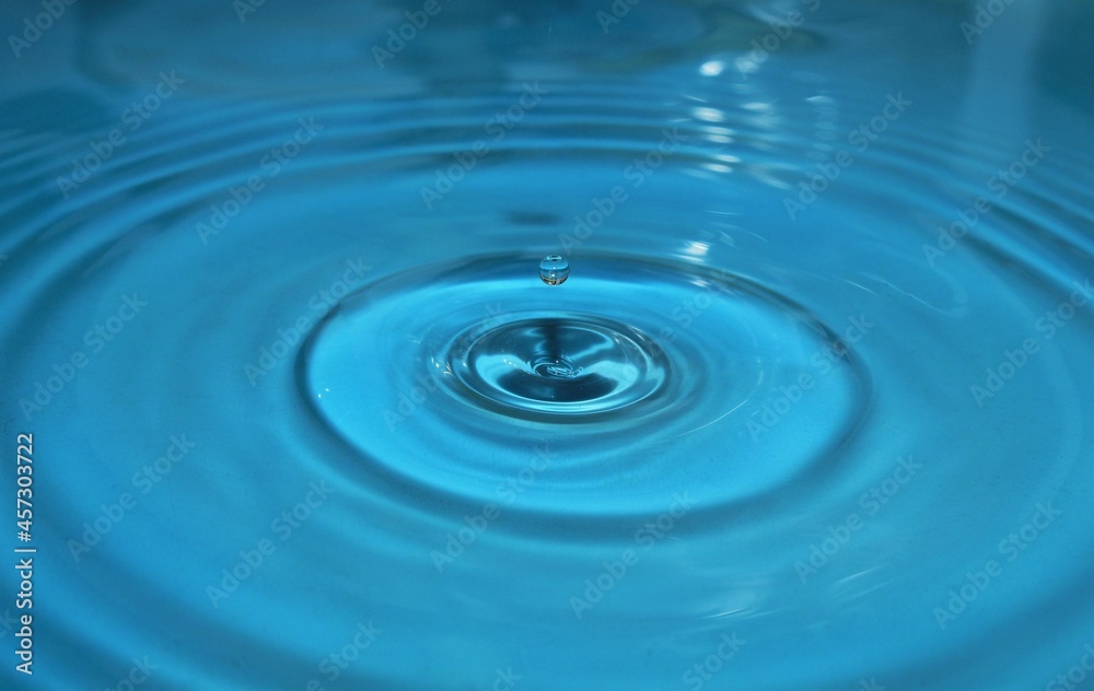 water drop splash background blue, water ripple and antibubble drop - water surface tension water drop splash background blue, water ripple and antibubble drop - water surface tension