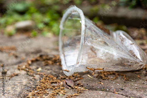 Crushed disposable plastic cup lying on the ground