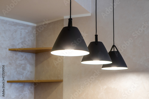 Close-up of black lamps on ceiling. Modern interior. photo