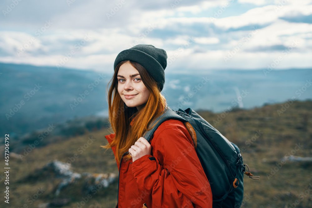 cheerful woman hiker walking in the mountains active vacation travel