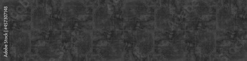 Grunge dark black anthracite gray grey concrete cement stone tiles square mosaic texture banner panorama. © Corri Seizinger