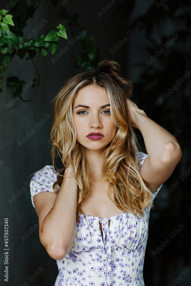 Portrait of a beautiful young attractive blonde girl in a summer dress Portrait of a beautiful young attractive blonde girl in a summer dress
