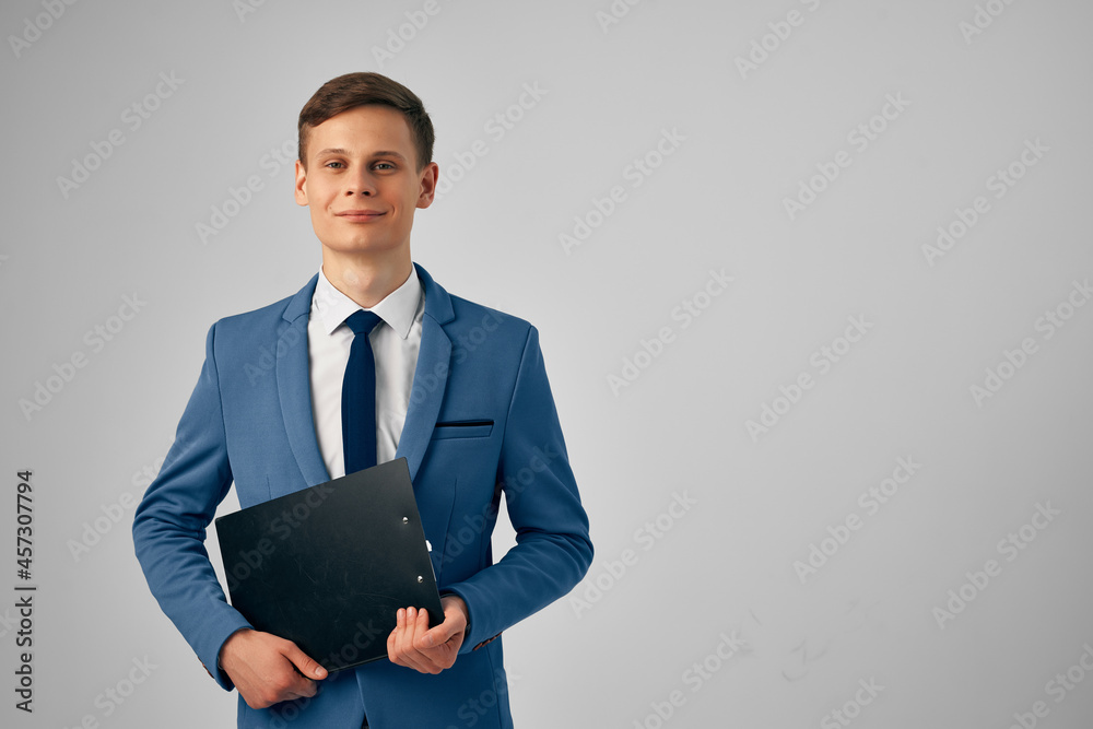 man in a suit with documents in his hands professional office light background man in a suit with documents in his hands professional office light background