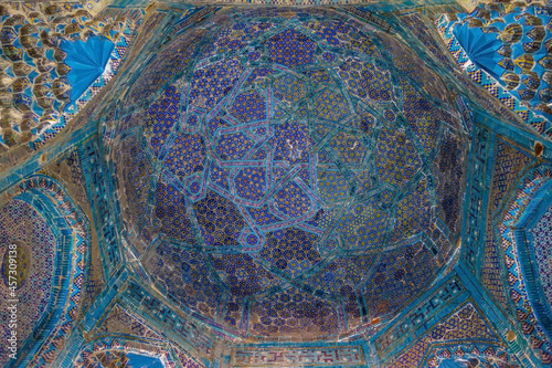 Vault of mausoleum luxuriously decorated with patterns. Mausoleum is nameless, conventional name is Alim Nasafi. Historical complex Shah-i-Zinda, Samarkand, Uzbekistan photo