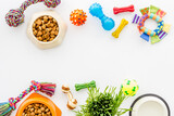 Dry dog food in bowl with toys and treats, top view