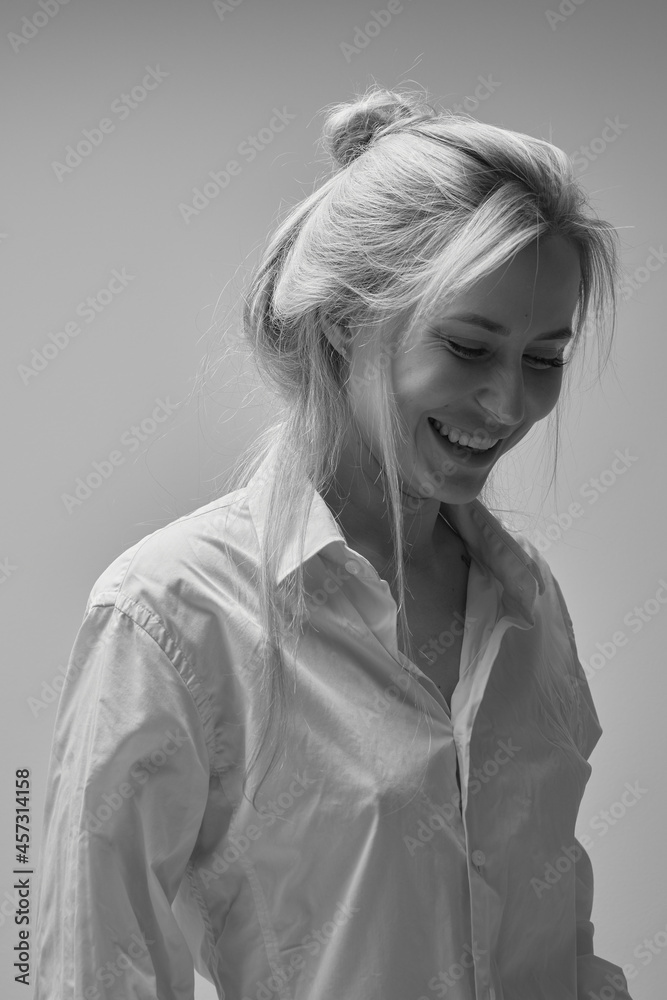 Close up black white portrait of sexy blond young woman in white mens shirt posing at home, happy girl smiling and laughing studio shot Close up black white portrait of sexy blond young woman in white mens shirt posing at home, happy girl smiling and laughing studio shot