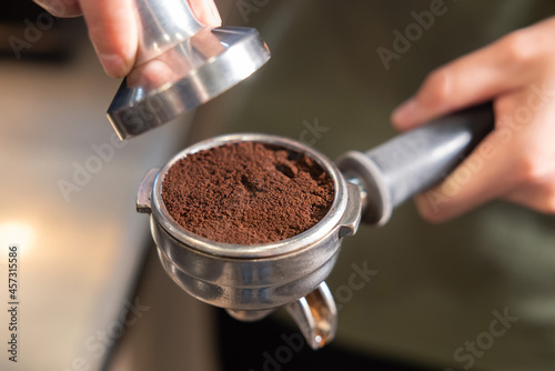 Barista Use Tamper to Press Ground Coffee