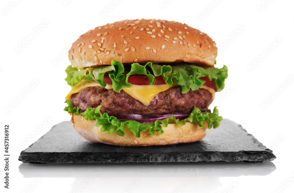 Appetizing burger with cutlet on slate board isolated on white Appetizing burger with cutlet on slate board isolated on white