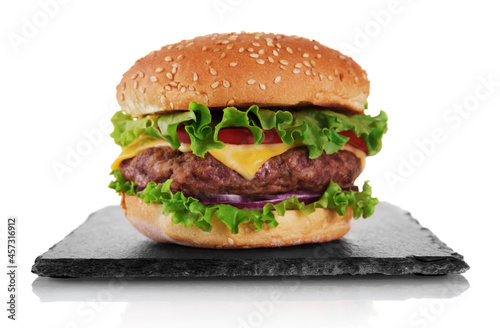 Appetizing burger with cutlet on slate board isolated on white