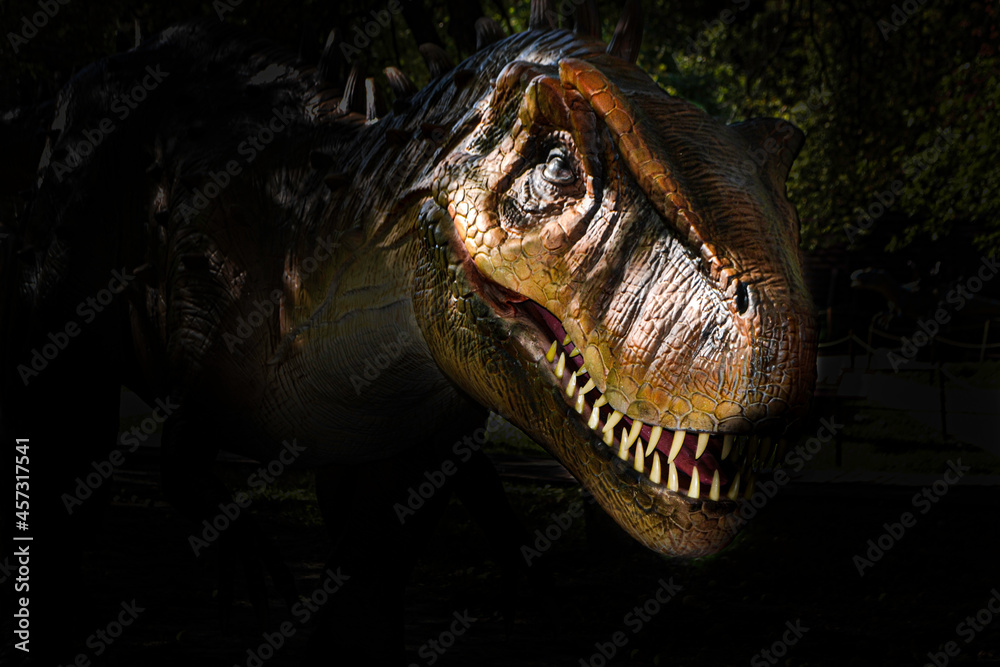 Obraz premium The head of dinosaur in the dark background