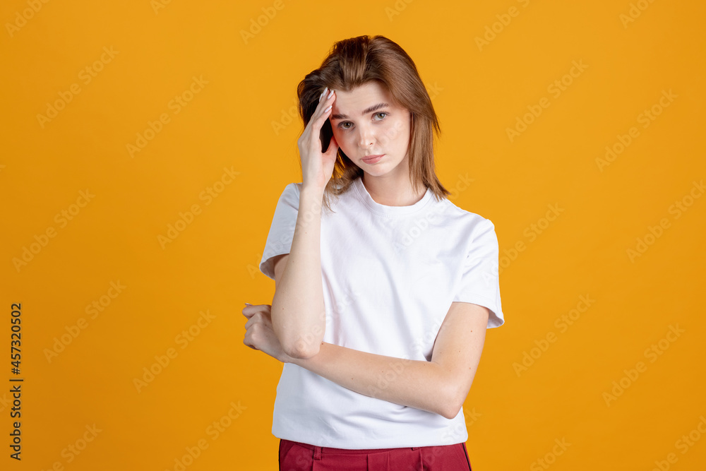 Studio shot of young pretty girl isolated on yellow color studio background. Concept of human emotions, facial expression, natural beauty, appearance, youth Studio shot of young pretty girl isolated on yellow color studio background. Concept of human emotions, facial expression, natural beauty, appearance, youth