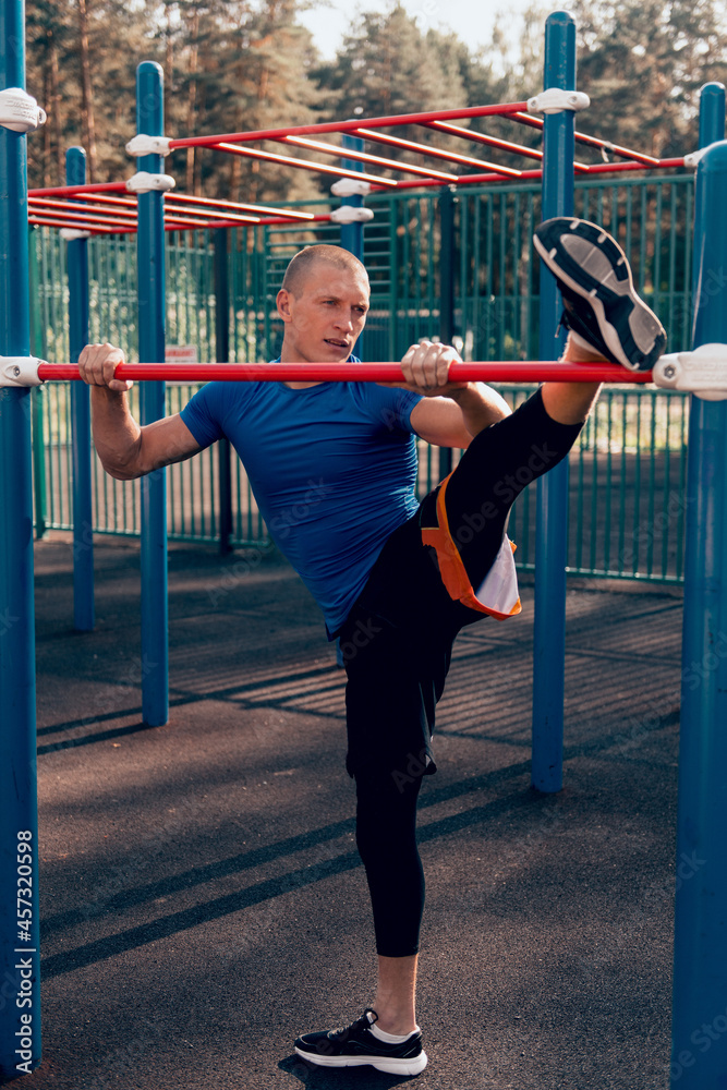 Fototapeta premium athlete doing stretching exercises workout on sports ground