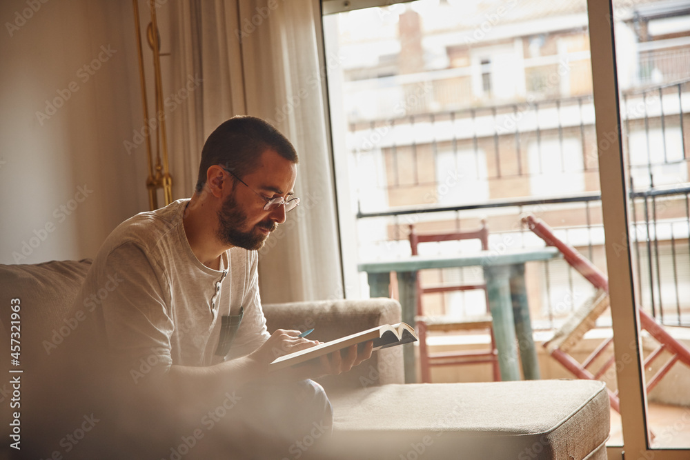 Fototapeta premium Occupied middle-aged man perusing a book