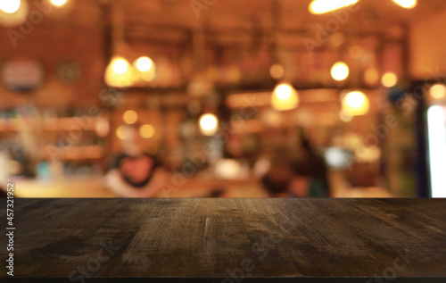 Empty wooden table in front of abstract blurred background of coffee shop . can be used for display or montage your products.Mock up for display of product