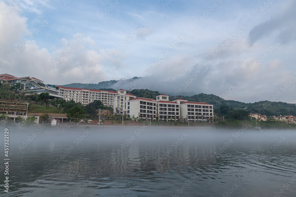 The scenery on both sides of the river in the morning fog The scenery on both sides of the river in the morning fog