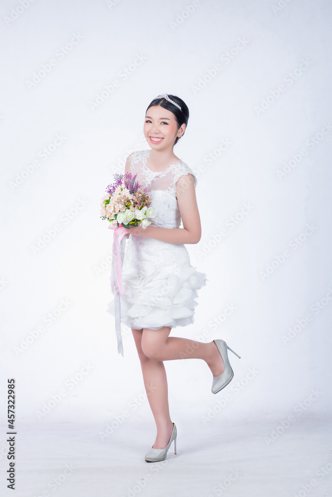 cute single girl hold bouquet in white dress on wedding day cute single girl hold bouquet in white dress on wedding day