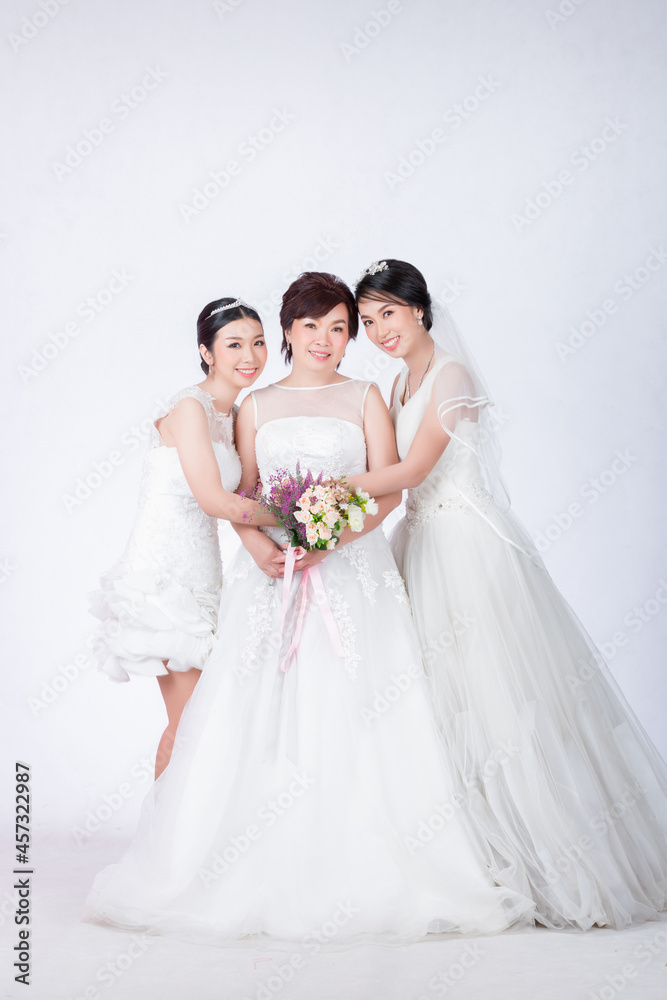 beautiful mother and cute daughters in white dress