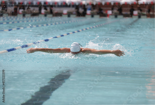 A swimmer is competing in a butterfly stroke.