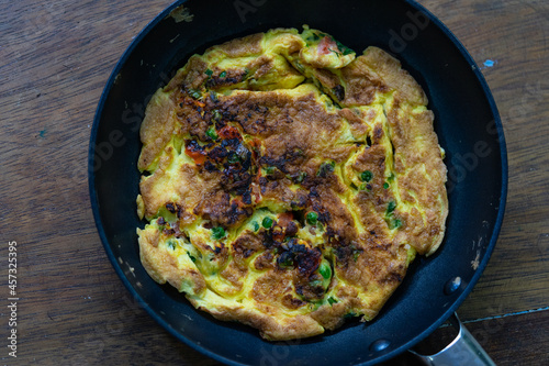 Hot omelet in skillet ready to eat.
