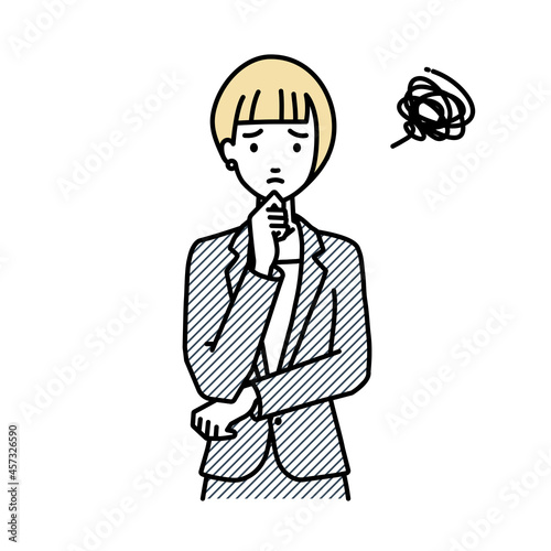 立って手をあごにあてて困っているスーツの女性