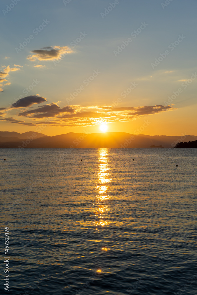 Beautiful sunrise on the shore of the blue sea, Gorgeous colorful landscape, Corfu Island, Greece