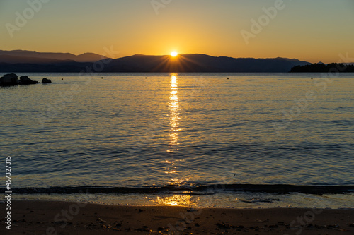Beautiful sunrise on the shore of the blue sea  Gorgeous colorful landscape  Corfu Island  Greece