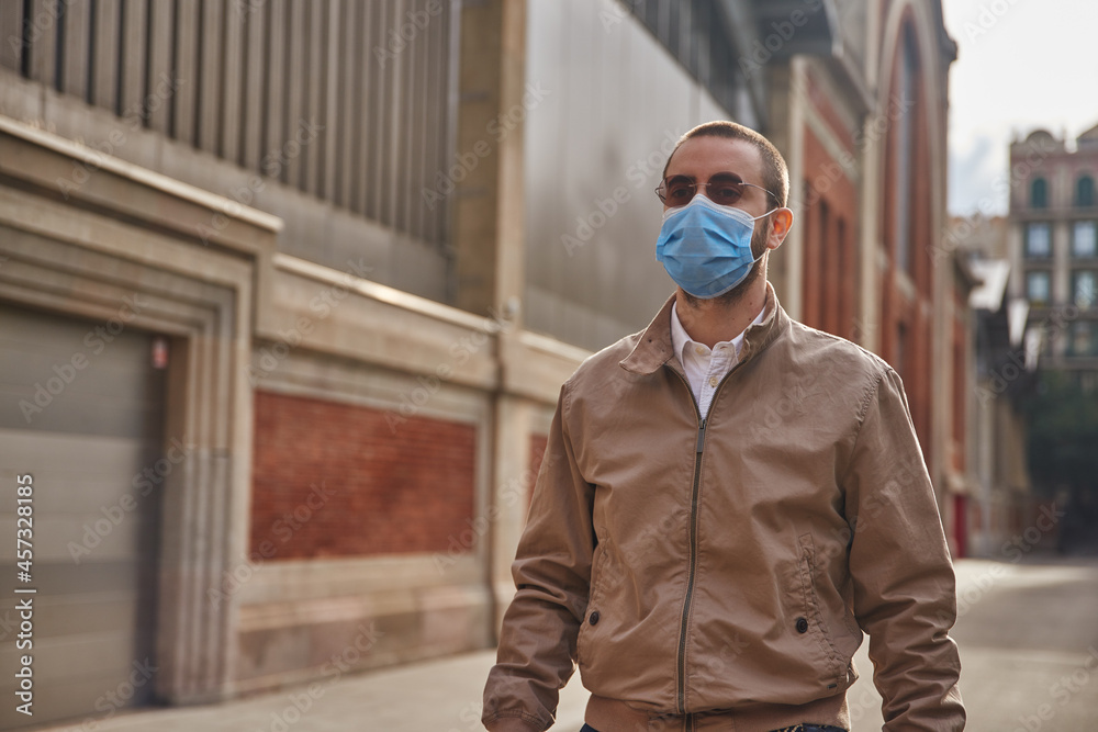 Naklejka premium A calm middle-aged man standing along a street