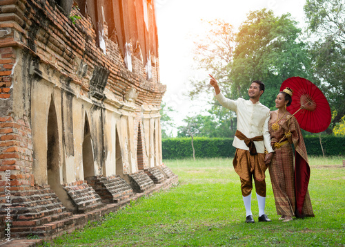 Thai couple wear Thai traditional wedding dress at ancient place. wedding ceremony, asian thai ceremony, thailand culture and romantic couples concept.