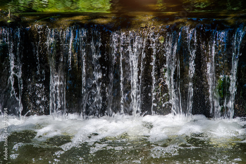 River waterfall in the summer Park
