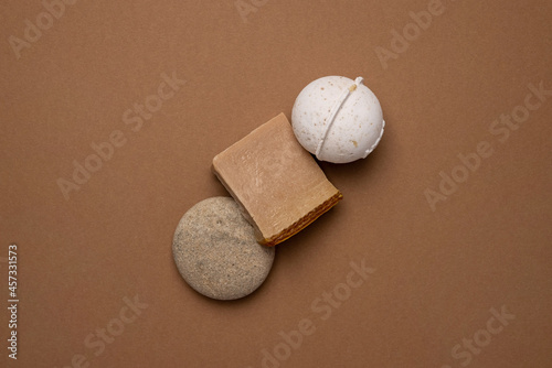 Various spa and beauty threatment products on brown background, eco handmade soup and Vanilla aroma bath bomb in trend color photo
