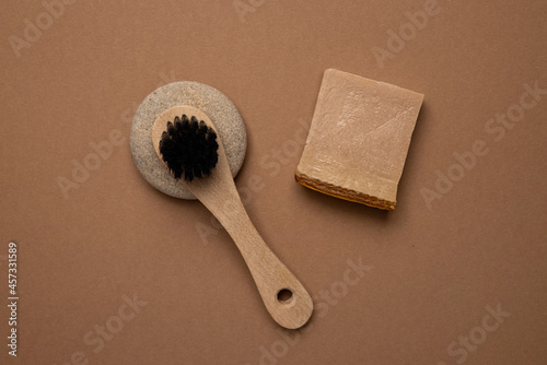 Various spa and beauty threatment products on brown background, eco handmade soup and natural brush in trend color photo