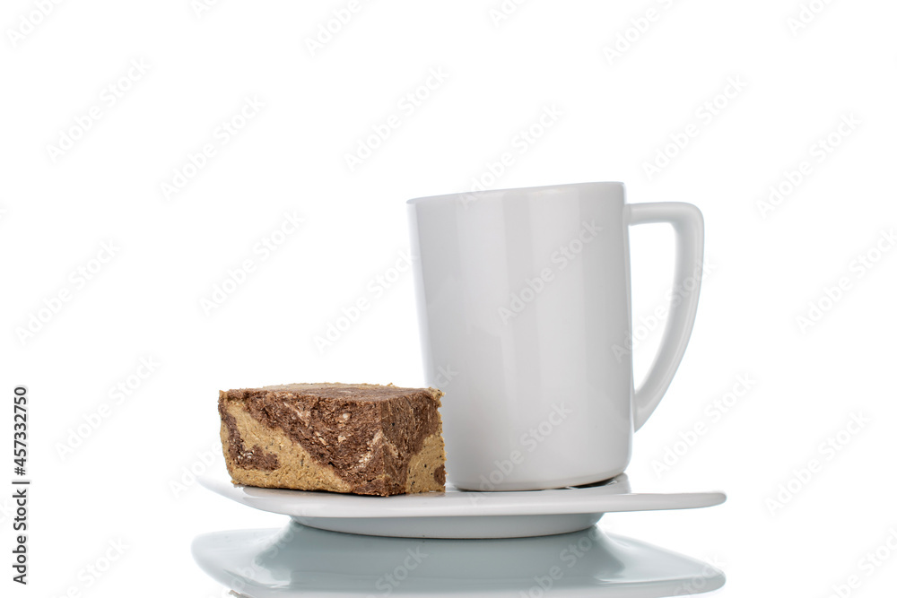 Pieces of sweet halva with chocolate on a white saucer with a white cup, close-up, isolated on white. Pieces of sweet halva with chocolate on a white saucer with a white cup, close-up, isolated on white.