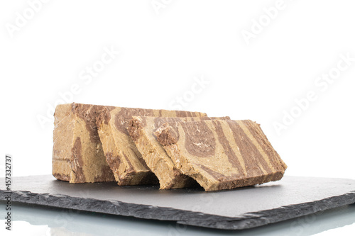 Pieces of sweet halva with chocolate on a slate stone, close-up, isolated on white. photo