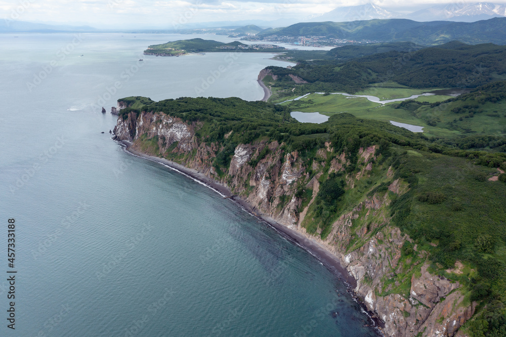 Fototapeta premium Aerial drone photo of Mayachny Cape on Kamchatka Peninsula on picturesque Avacha bay coast covered by green grass in the Pacific Ocean