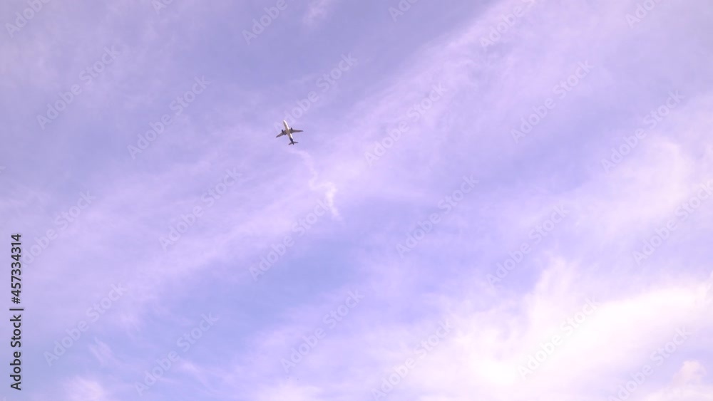 Airplane flying in a blue sky with soft clouds. Airplane flying in a blue sky with soft clouds.