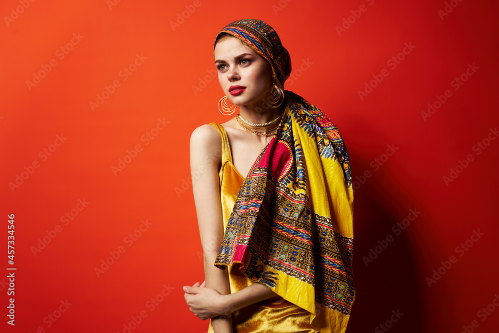 cheerful woman in multicolored turban attractive look Jewelry red background cheerful woman in multicolored turban attractive look Jewelry red background