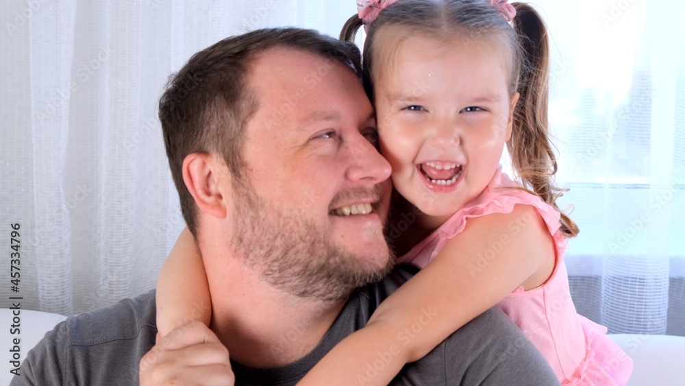 smiling Little daughter 3 years old and father gently hug and have fun at home. have fun with your baby, fool concept. fathers day. parenting, relationships between children and parents smiling Little daughter 3 years old and father gently hug and have fun at home. have fun with your baby, fool concept. fathers day. parenting, relationships between children and parents