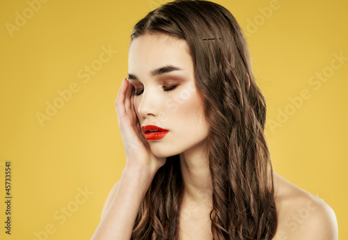 woman with red lips hairstyle fashion close up yellow background