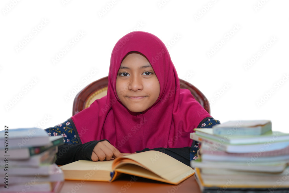A young female muslim teenager wearing hijab is studying isolated on white background A young female muslim teenager wearing hijab is studying isolated on white background
