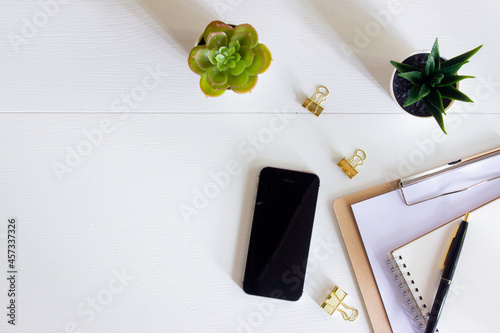 Working items on a white table with nature light. 