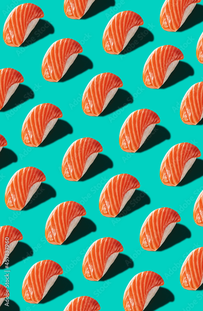 Pattern of nigiri with salmon isolated on turquoise background Pattern of nigiri with salmon isolated on turquoise background