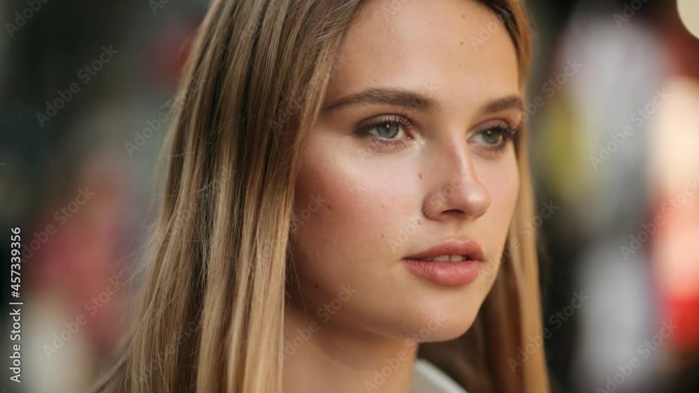 Closeup face of beautiful blond smiling woman with long hair. Portrait of gorgeous girl looking to camera Closeup face of beautiful blond smiling woman with long hair. Portrait of gorgeous girl looking to camera