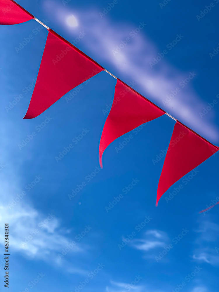 red flags on white rope against the sky red flags on white rope against the sky