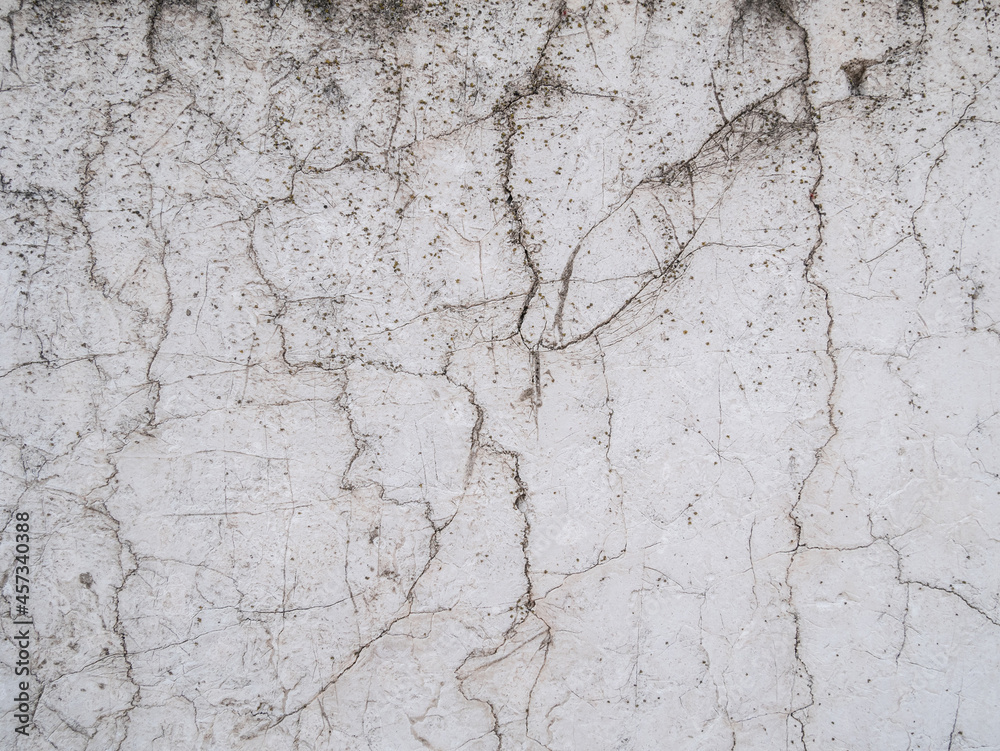 White cracked wall abstract background texture pattern.