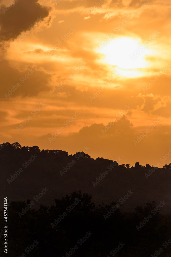 silhouette mountain with attractive background, sunset with vivid yellow sky