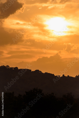 silhouette mountain with attractive background  sunset with vivid yellow sky