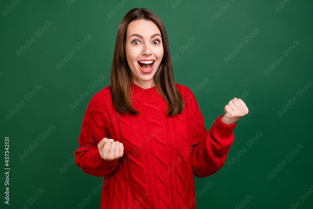 Photo of young excited girl happy positive smile rejoice win victory lucky ecstatic isolated over green color background