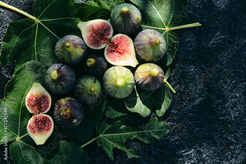 Fresh figs placed on top of green leaves photo
