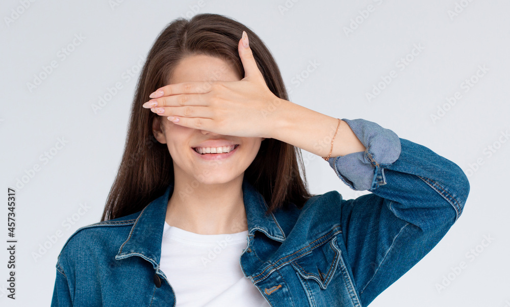 Young european woman with hand over eyes, studio white background Young european woman with hand over eyes, studio white background