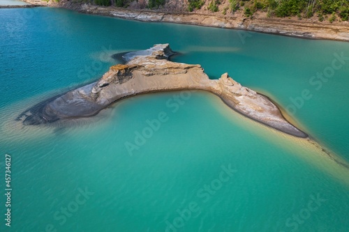 Drone view of the turquoise lake formed as a result of mining waste photo